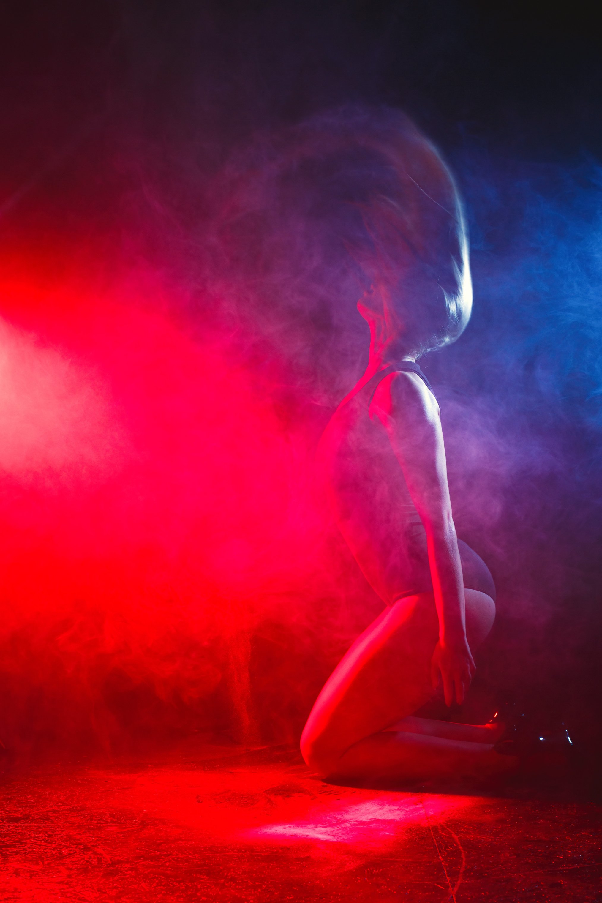 Photo of a Woman Doing  a Hair Flip Near Lights